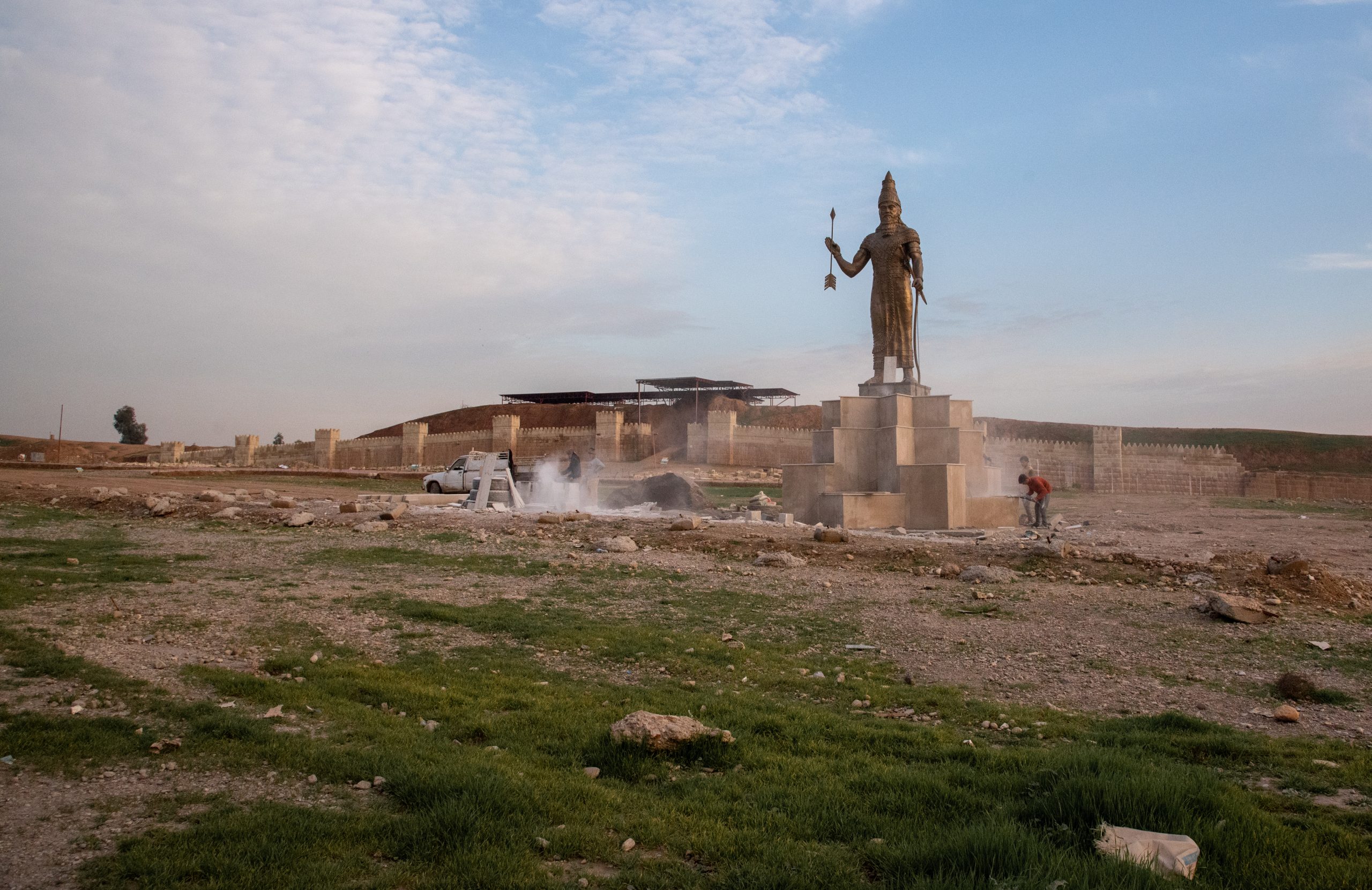 Workers putting the finishing touches to a statue of King Synchrib