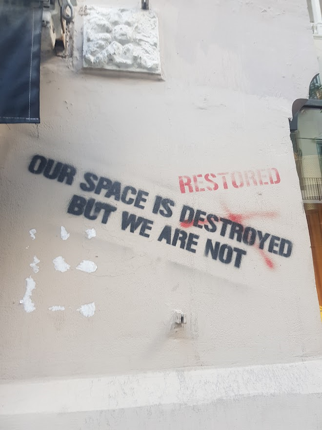 Graffiti on a wall in Beirut, which reads 'Our space is destroyed but we are not'.