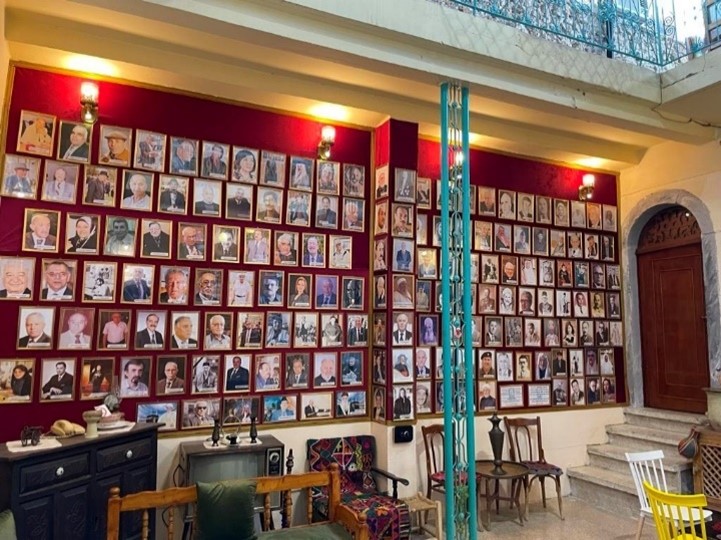Portraits of public figures adorn the wall of Baytna.