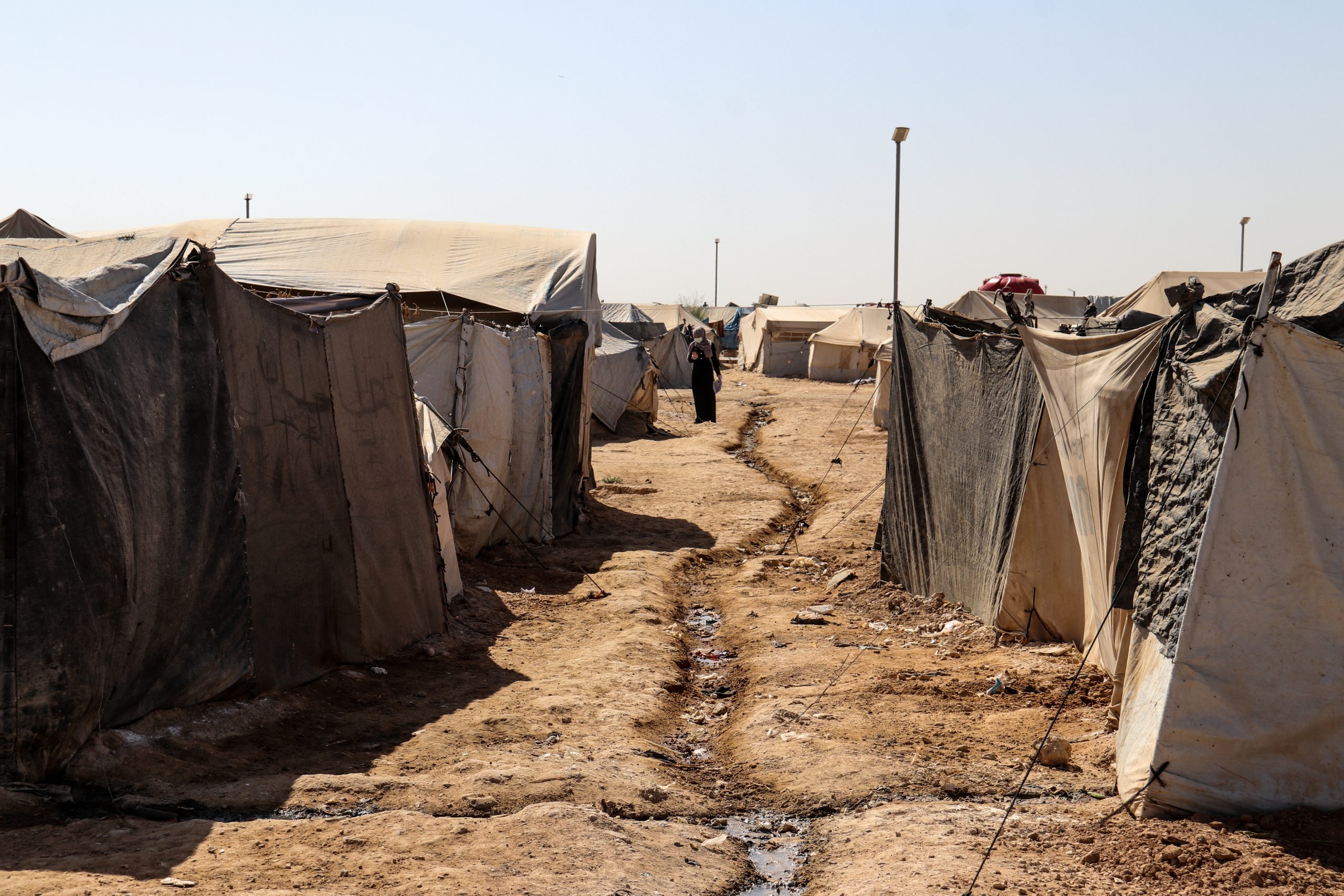 Tents line a rough path in al-Hol camp in Syria