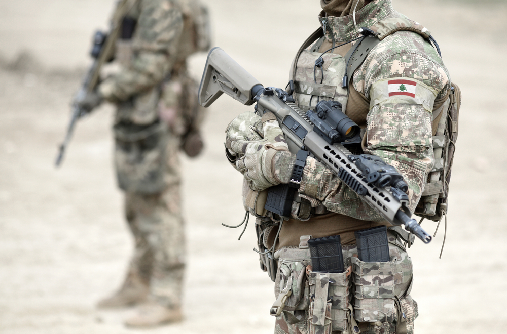 Two soldiers dressed in army uniform. The Lebanese flag can be seen on the arm of the closest soldier