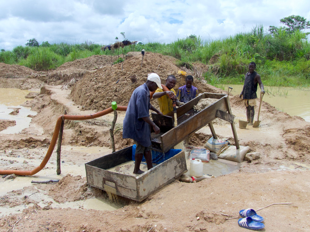 A group of men washing soil